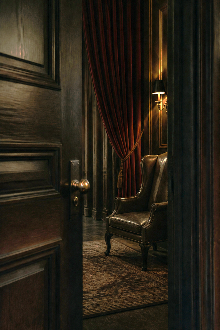 A velvet-curtained room inside The Ledger, a leather chair waiting under lamplight